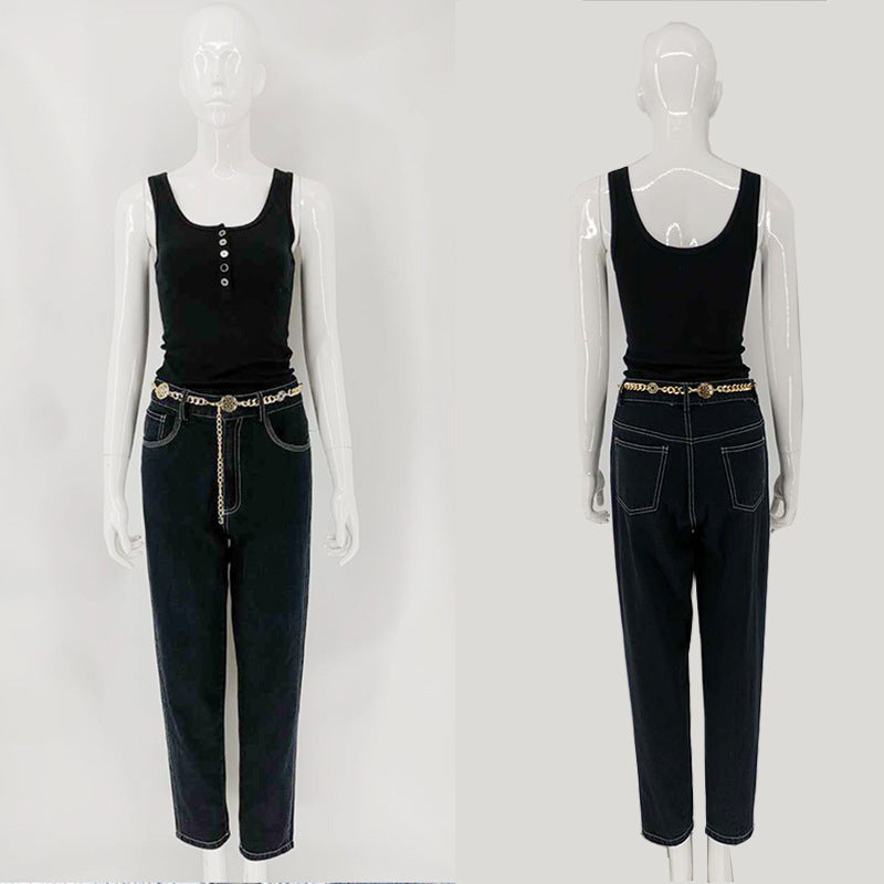 A woman with a simple black round-neck short vest and jeans