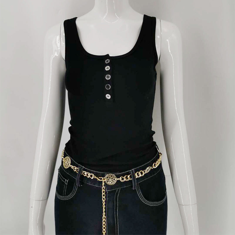 A woman with a simple black round-neck short vest and jeans