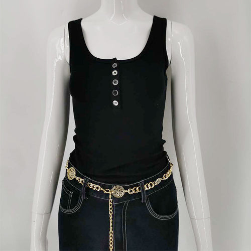A woman with a simple black round-neck short vest and jeans
