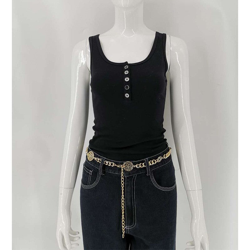 A woman with a simple black round-neck short vest and jeans